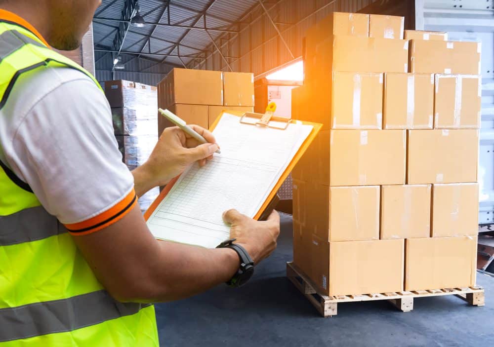 Shipping-boxes-with-warehouse-workers Shipping boxes and warehouse worker